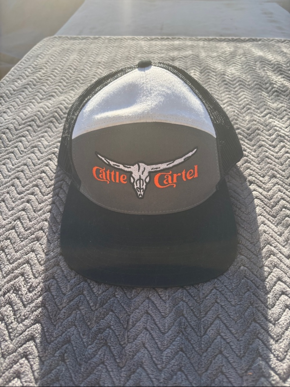 Cattle Cartel Black and White Trucker Cap with Orange Logo